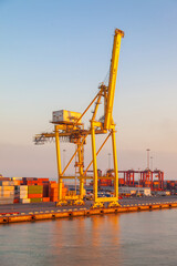 Fototapeta premium big yellow crane of the industrial port on the mediterranean