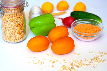 Healthy food apricots, cucumber, radish, red lentils, dry peas, garlic, yellow tomatoes, sweet green pepper, cucumber and oatmeal