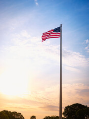 American Flag at Dawn. Rising Sun and Waving Flag. Sign for Hope and Promises.