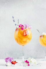 Lavender sangria with peach, apricot and strawberry, decorated with hyacinth flowers