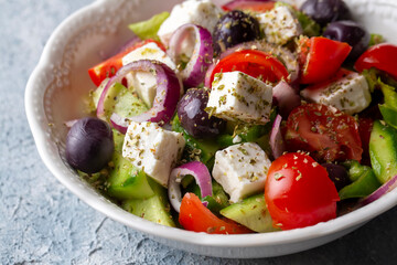 Greek salad with fresh vegetables, feta cheese and kalamata olives. Healthy food.