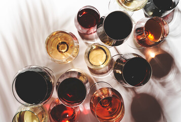 Red, rose and white wine in glasses on white background, top view. Wine bar, shop, winery, wine...