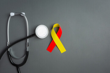 World hepatitis day awareness with red yellow ribbon