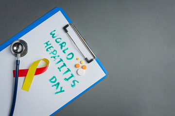 world hepatitis day concept with medical tools and pills placed on gray background