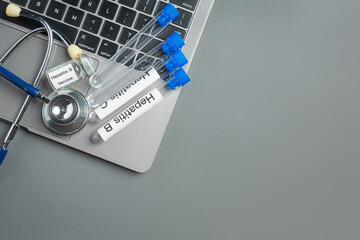 world hepatitis day concept with medical tools and pills placed on gray background