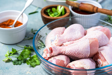 Raw Chicken Legs Drumstickswith Skin in Bowl. Food for BBQ Grill Preparation