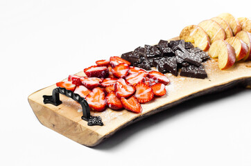 Red strawberries on a wooden tray on a white background. Isolated. Summer fruits.