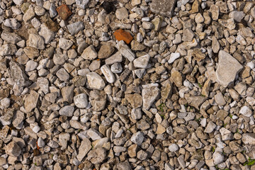 The texture of river stones and rubble on the river bank.