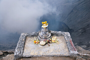 Ganesha statue : Lord of Success on Crater mouth of Bromo mountain with smoke volcanic at Bromo Mountain is active vocalno in Indonesia.