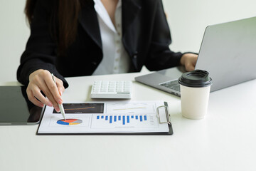Financial Businesswoman analyze the graph of the company's performance to create profits and...