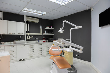 Fototapeta na wymiar Interior dental clinic with dark gray wall.