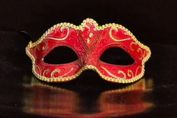 Venetian Masks with white light trails on a black reflective background