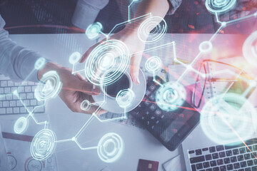 Double exposure of man and woman working together and social network theme hologram drawing. Computer background. connecting concept. Top View.