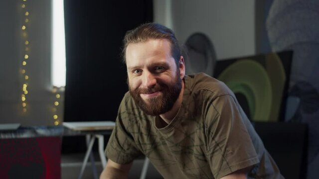 A smiling painter is looking at the camera 