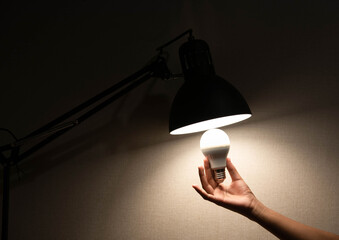 man is changing the reading lamp