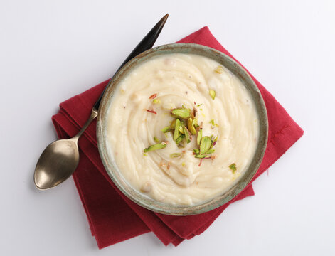 Shrikhand is an Indian sweet dish made of strained yogurt, garnished with dry fruits and saffron. 