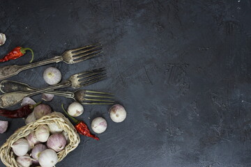 dried chili peppers and garlic on dark background