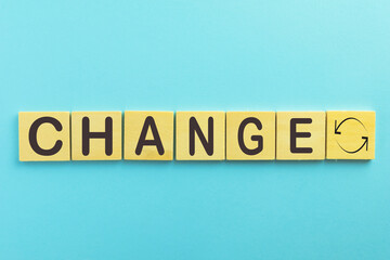 Change word on wooden cube over blue sky background with copyspace use for positive thinking,business,challenge,change yourself concept.