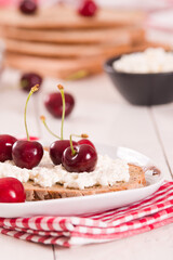 Rye bread with cottage cheese and cherries.