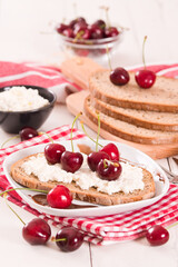 Rye bread with cottage cheese and cherries.