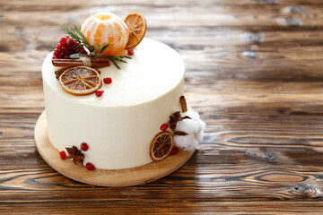 Minimalistic single tier wedding cake with white icing and decoration. Close up, copy space for text, background, top view.