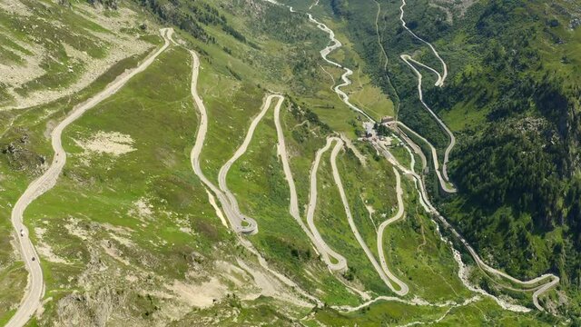 Slow aerial climb over winding pass road to Grimselpass in the swiss alps