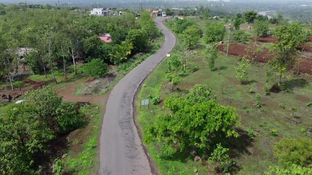 Aerial footage of a road with traffic at village Bhor near Pune India.