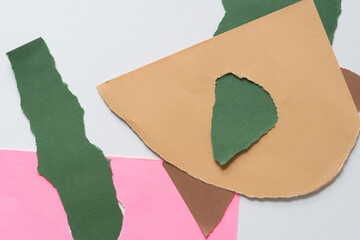 sand brown, green, and pink torn paper background