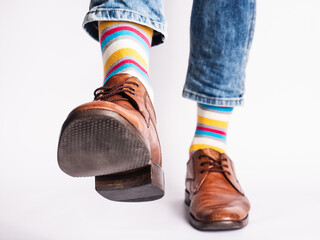 Men's legs, trendy shoes and bright socks. Close-up. Style, beauty and elegance concept