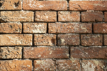 Textured red brick wall from old stones