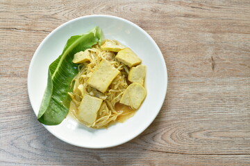 fried bean sprout with slice yellow tofu in plate on table