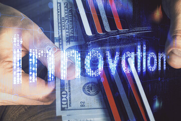 Double exposure of technology drawing hologram and us dollars bills and man hands. Data concept