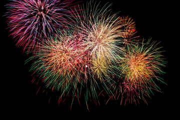 Colorful fireworks display surrounding a full moon in a dark night sky