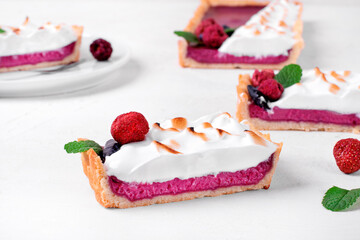 Berry tart with shortcrust topped with torched meringue, raspberry, strawberry and honeysuckle....