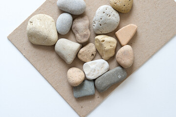 Fototapeta na wymiar stones on sand-coloured mill board