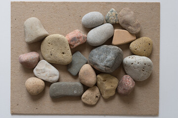 Fototapeta na wymiar stones on the sand-coloured mill board