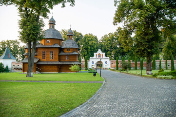 Krekhovsky monastery - a view of the old wooden church of the Most Holy Theotokos and the monastery gates. - 440597488