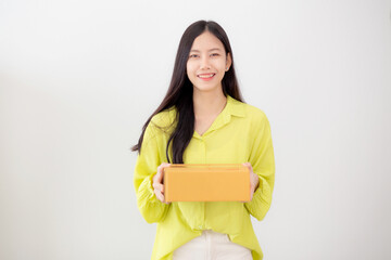 Obraz premium Young asian woman smiling and holding cardboard box at home, happy female carrying parcel box giving, present and gift, packaging for deliver, online shopping store and service concept.