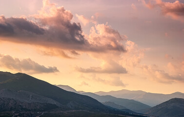Sudak, Crimea - the ridge of the Crimean mountains against the background of a sunset sky with beautiful clouds.