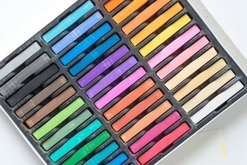 array of colorful chalk pastels in box set 