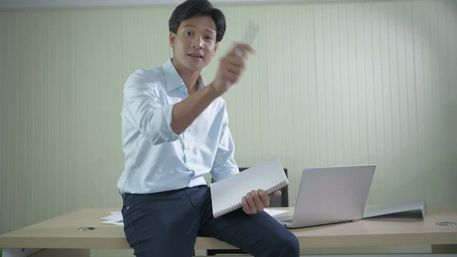 Business concept of 4k Resolution. Asian man presenting marketing information in the office.
