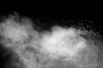 White powder explosion cloud against black background.White dust particles splash.