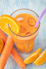 carrot and orange fresh juice on blue table