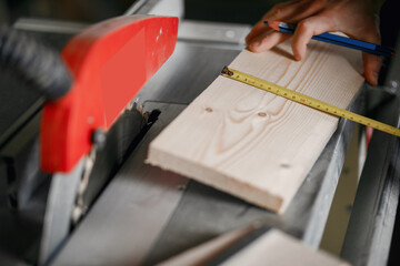 Man in the workshop with a wood