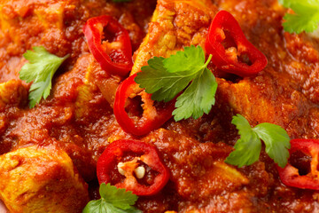Spicy Chicken Pathia curry with basmati rice in a white plate. healthy food.