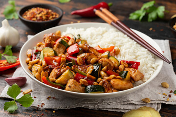 Kung Pao Chicken with Peppers, zucchini and rice. Asian take away food