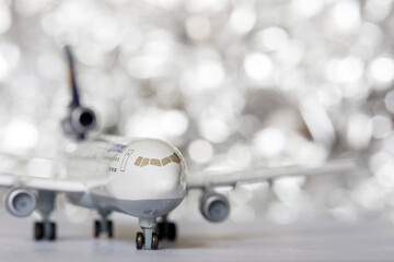 Fototapeta premium A passenger plane on a beautiful silver bokeh background. Background for air transport.