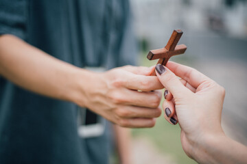 Hand with cross .Concept of hope, faith, christianity, religion, church online.