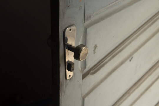 High Angle Shot Of A Doorknob On An Old White Door