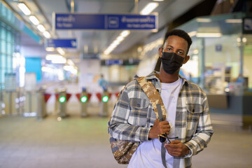 Portrait of African black man tourist in train terminal